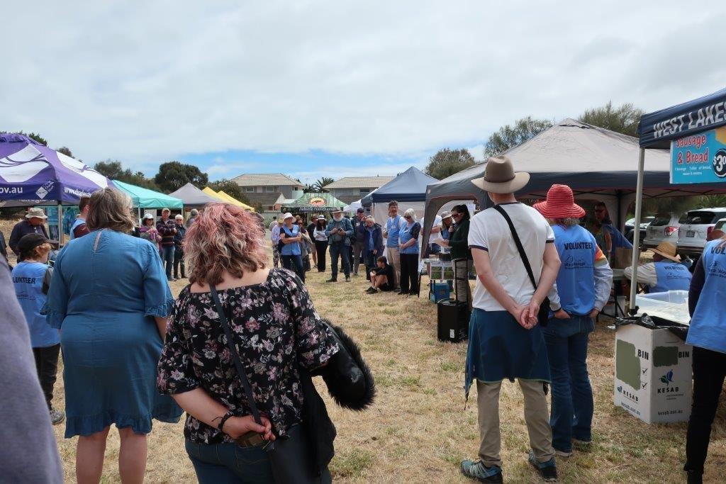 Dearnne Rich, third fron the right, is speaking in front of a crowd at Tennyson foreshore.